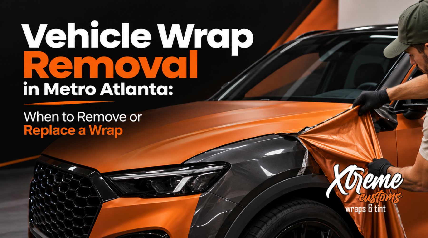 Professional technician removing an orange vinyl vehicle wrap from an SUV in Metro Atlanta to reveal the original paint beneath.