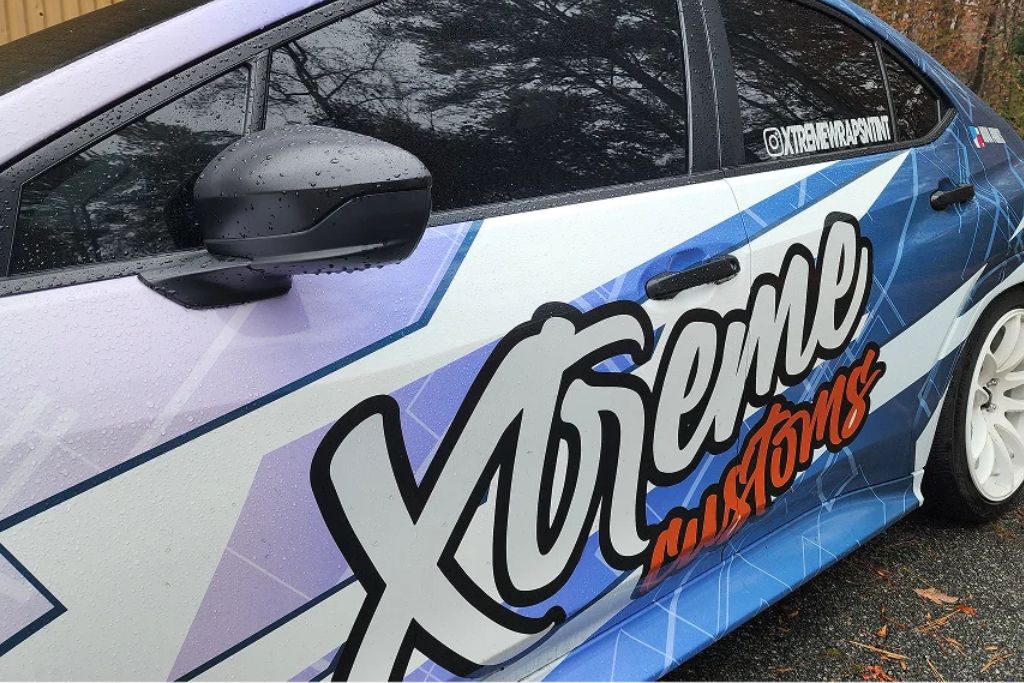 Close-up of a vehicle with a custom vinyl wrap showing a professional wrap finish, illustrating the type of graphics that should be inspected for fading, lifting, or wear over time.